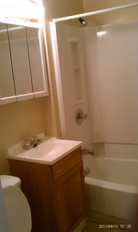 56 Windsor Street Springfield, MA 01105 - Photo 4 of 14 a bathroom with a sink a toilet and shower
