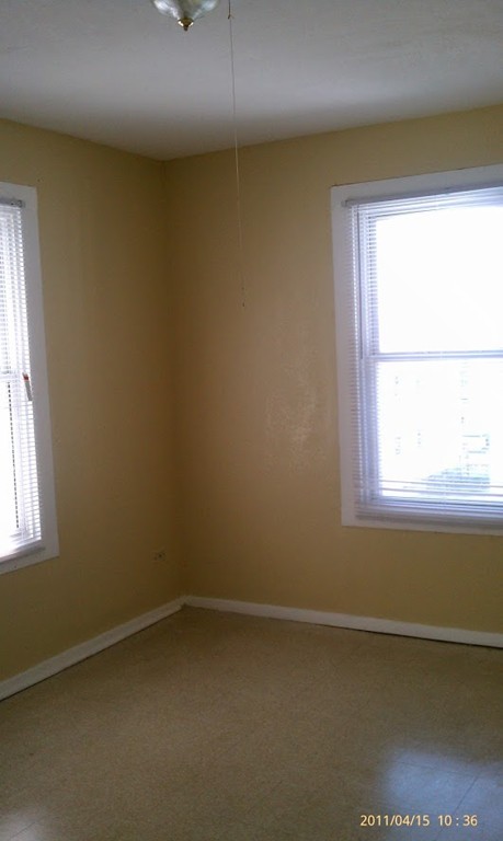 56 Windsor Street Springfield, MA 01105 - Photo 6 of 14 an empty room with a window