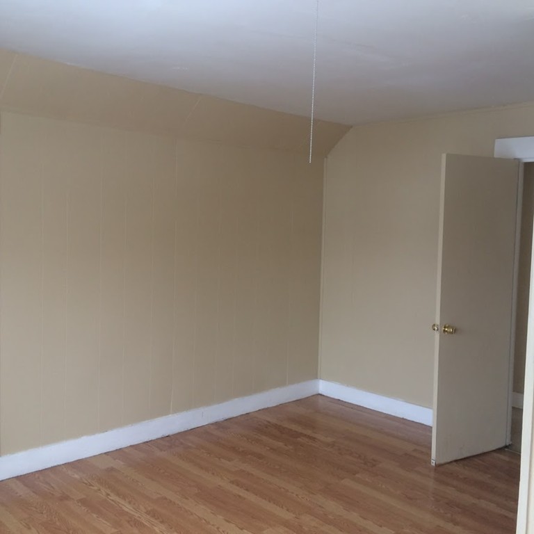 56 Windsor Street Springfield, MA 01105 - Photo 10 of 14 a view of an empty room with wooden floor
