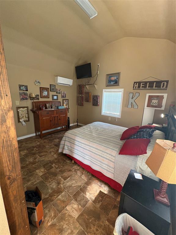 459 Dollie Moore Road Ringgold, LA 71068 - Photo 8 of 19 Vaulted ceiling with an exposed wood-finish beam, window with blinds, and durable tile-patterned flooring