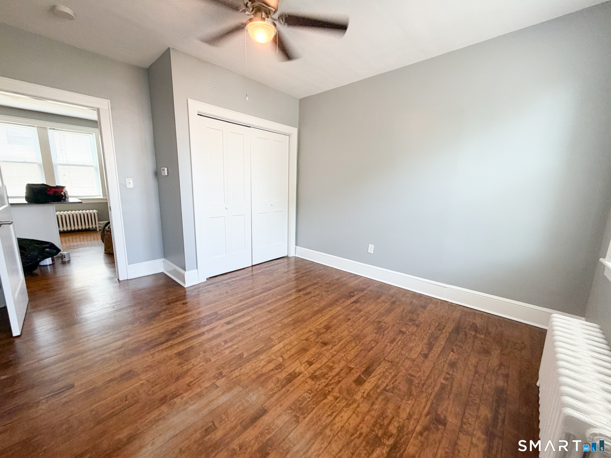 793 Milford Point Road, Unit 1 Milford, CT 06460 - Photo 11 of 16 wooden floor in an empty room with a window