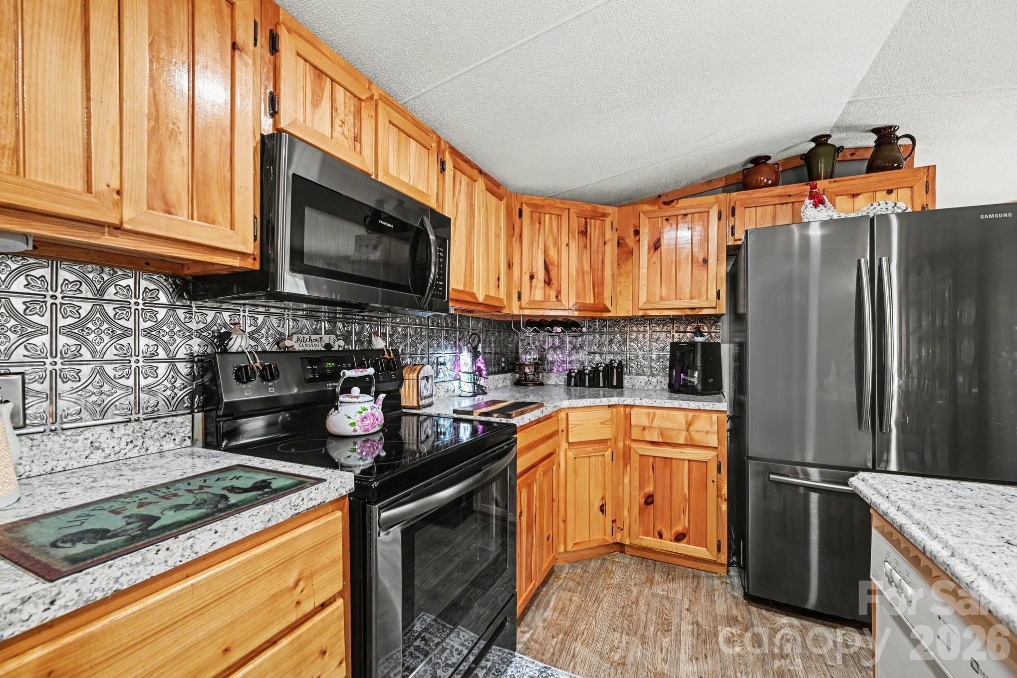 5431 Polkville Road Casar, NC 28020 - Photo 12 of 24 a kitchen with stainless steel appliances granite countertop a refrigerator stove and sink