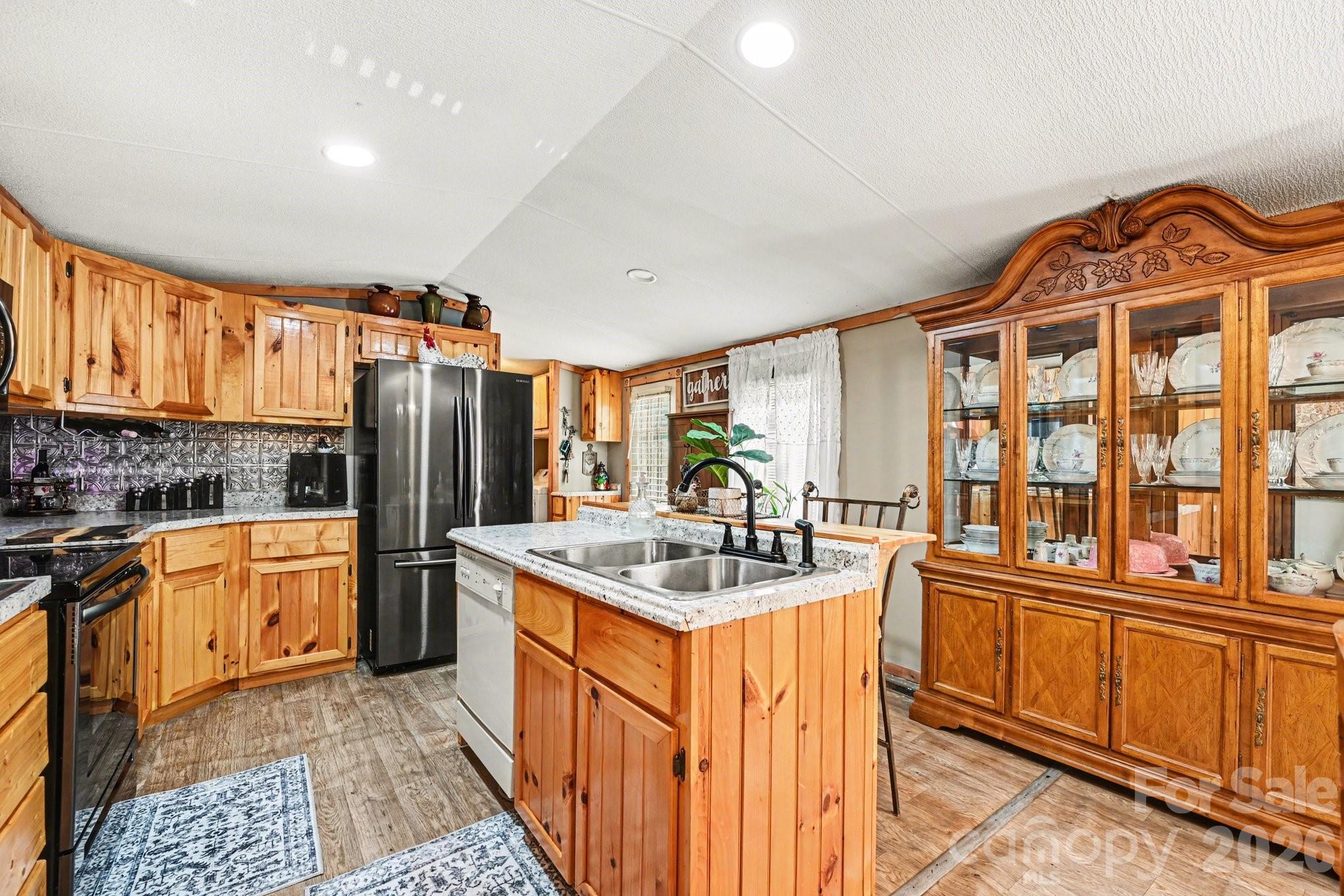 5431 Polkville Road Casar, NC 28020 - Photo 9 of 24 a kitchen with stainless steel appliances granite countertop a sink stove and refrigerator