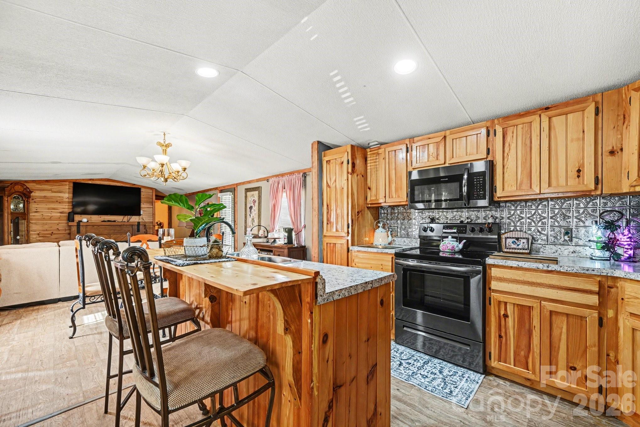 5431 Polkville Road Casar, NC 28020 - Photo 10 of 24 a kitchen with sink a stove and chairs