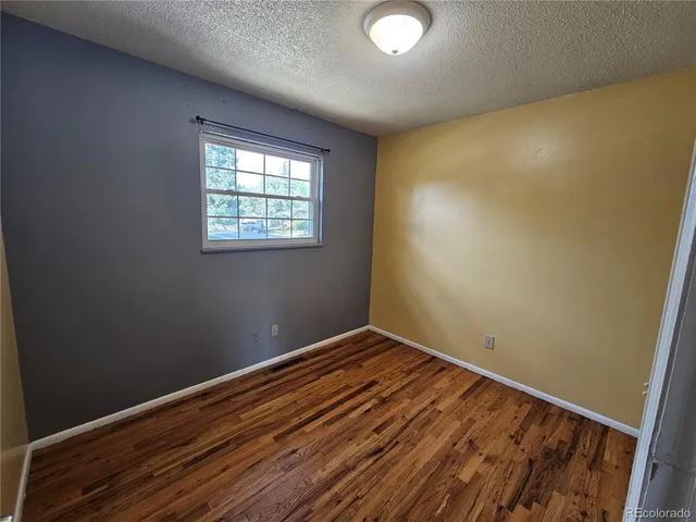 a view of room with window and hardwood floor