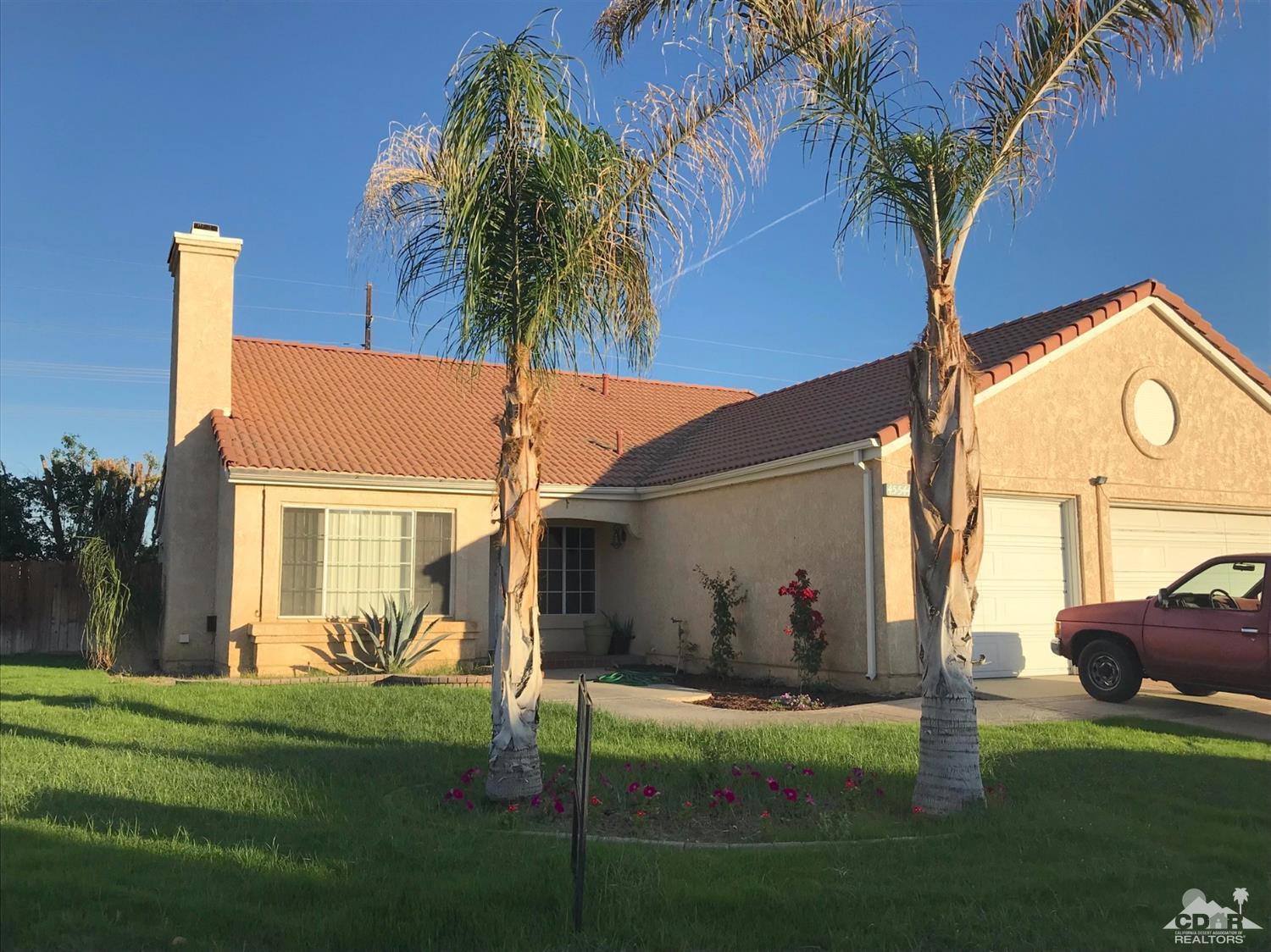 45544 Cimarron Road Indio, CA 92201 - Photo 3 of 5 a front view of house with yard and green space