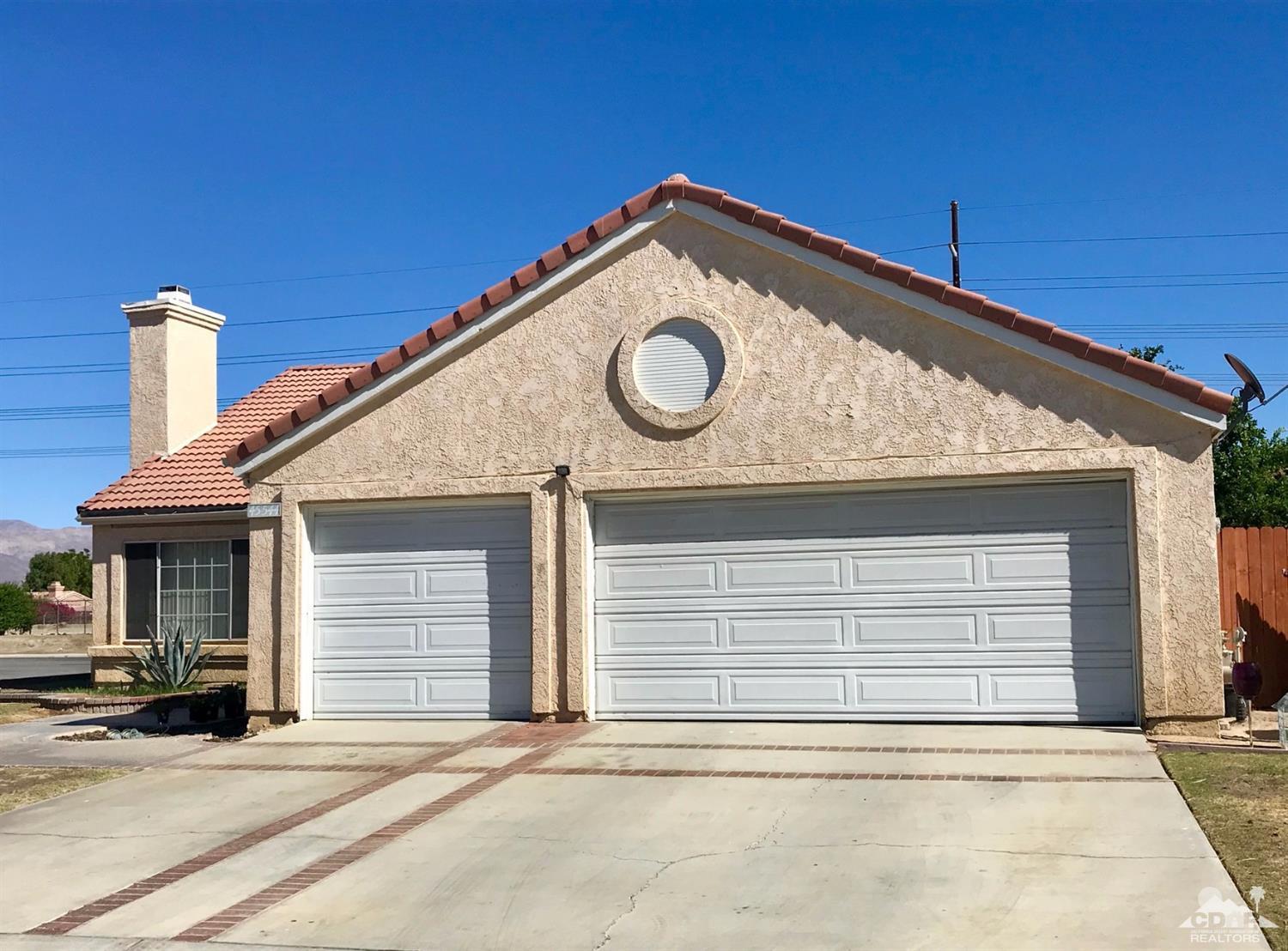 45544 Cimarron Road Indio, CA 92201 - Photo 5 of 5 a front view of a house with a garage