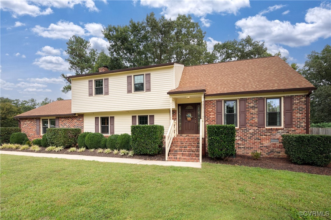 3510 Wood Dale Road Chester, VA 23831 - Photo 1 of 50 a front view of a house with a garden