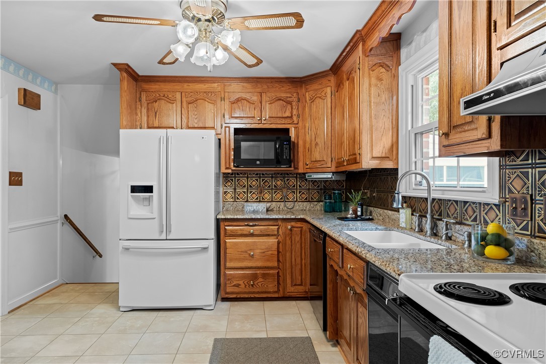 3510 Wood Dale Road Chester, VA 23831 - Photo 12 of 50 a kitchen with stainless steel appliances granite countertop a refrigerator a stove top oven a sink a dining table and chairs with wooden floor