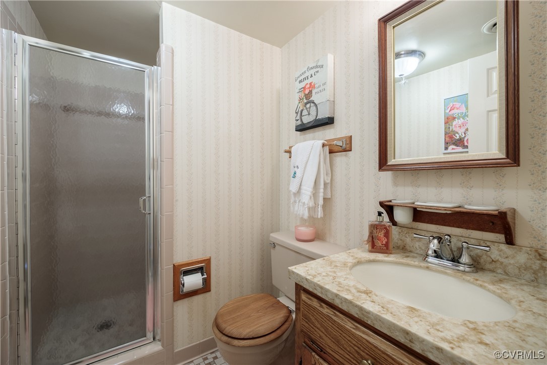 3510 Wood Dale Road Chester, VA 23831 - Photo 18 of 50 a bathroom with a granite countertop toilet sink and mirror
