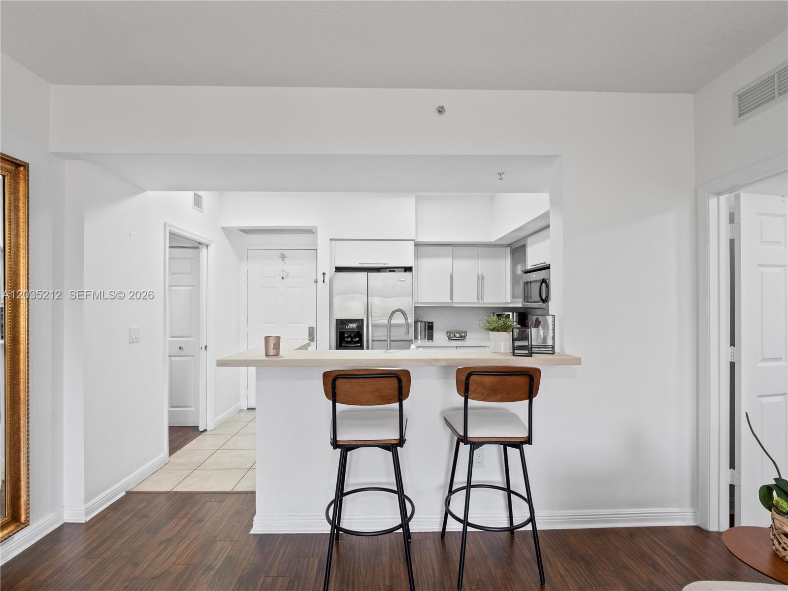 888 Douglas Road, Unit 302 Coral Gables, FL 33134 - Photo 16 of 51 KITCHEN WITH STAINLESS STEEL APPLIANCES, QUARTZ AND PORCELAIN FINISHES