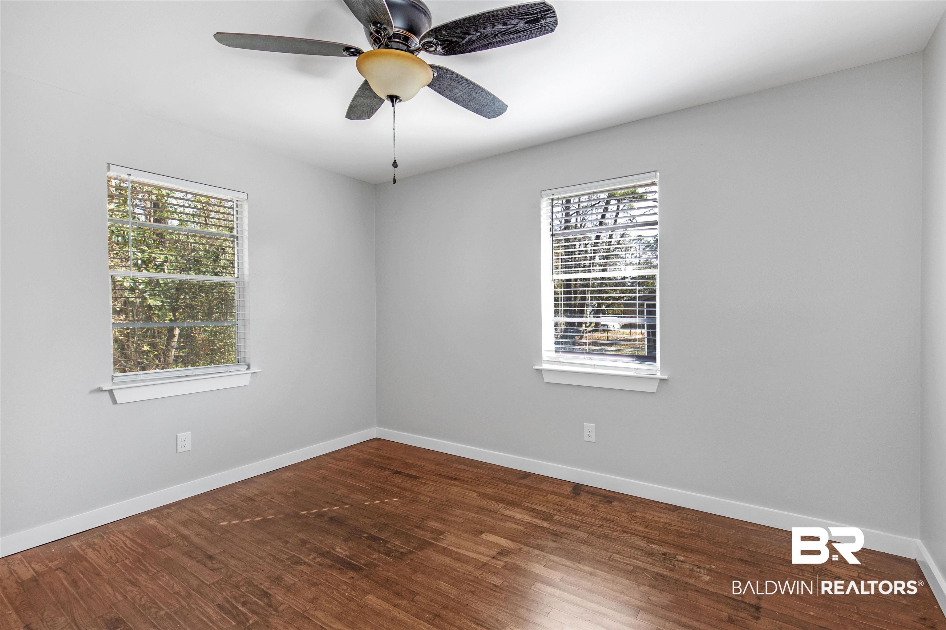 3005 Club House Road Mobile, AL 36605 - Photo 15 of 20 Spare room with ceiling fan, hardwood / wood-style flooring, and a healthy amount of sunlight