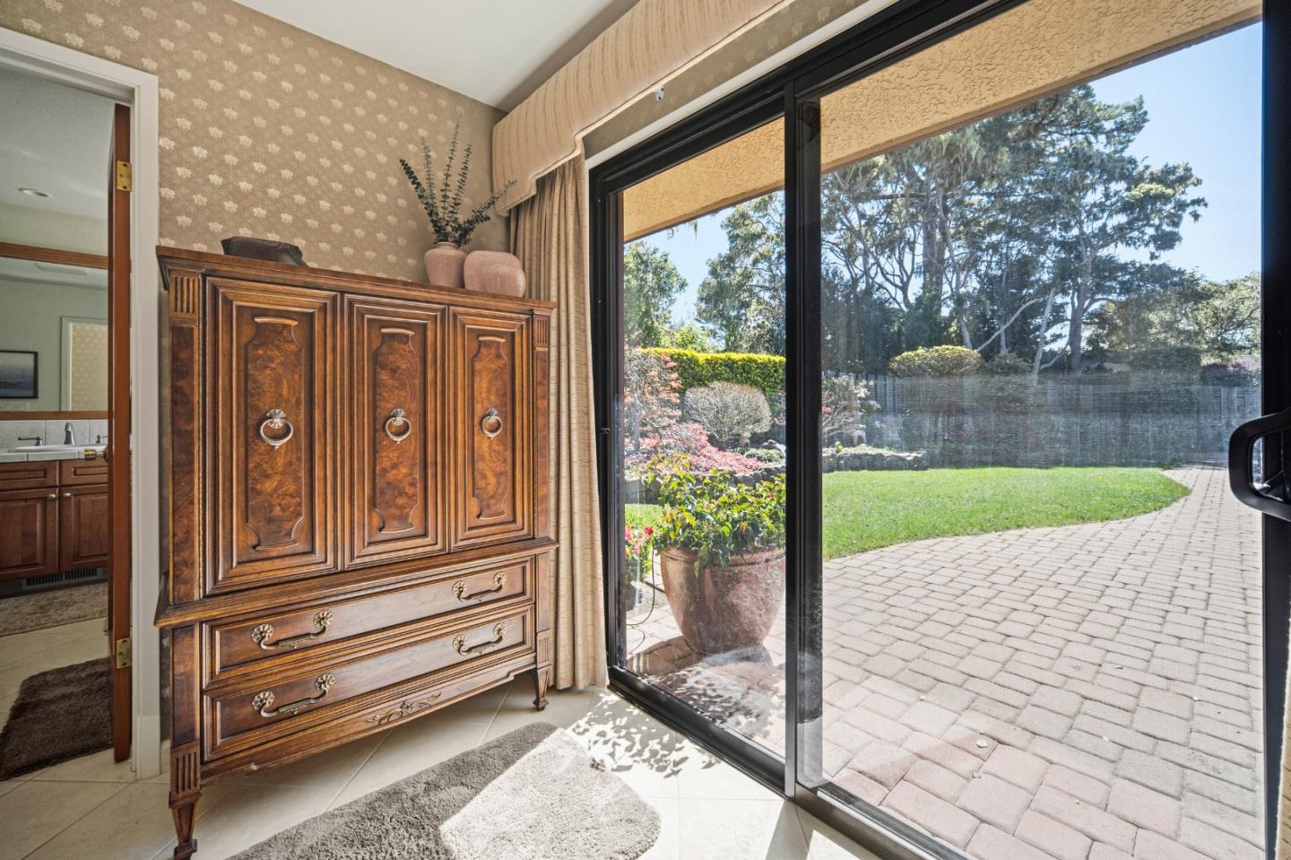 2911 Colton Road Pebble Beach, CA 93953 - Photo 27 of 46 a porch with a bench next to a yard