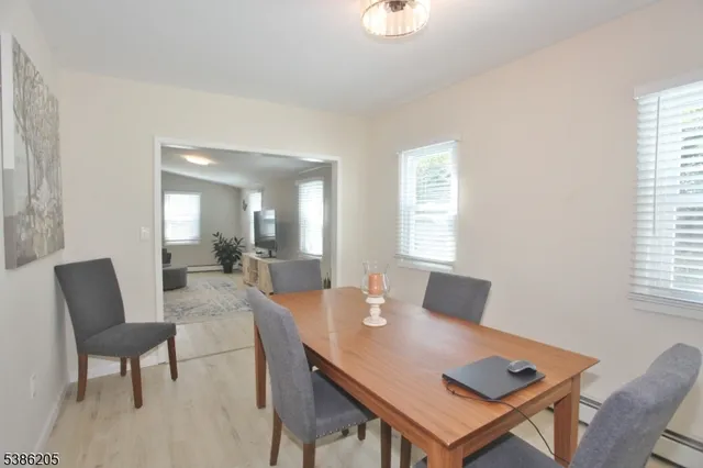 a view of a dining room with a table and chairs