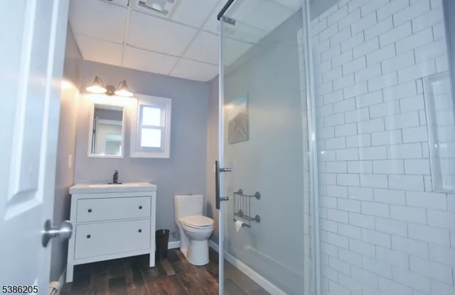 a bathroom with a sink a toilet and shower