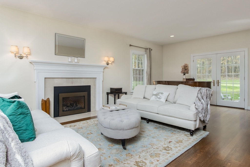326 Old Ayer Road Groton, MA 01450 - Photo 20 of 42 a living room with furniture a fireplace and a large window