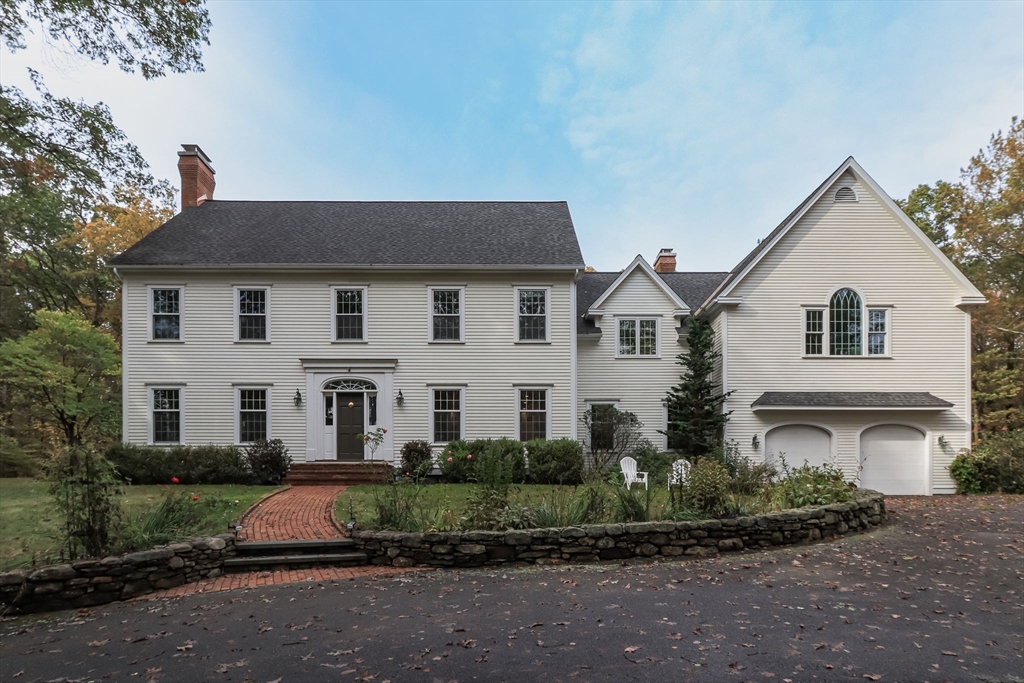 326 Old Ayer Road Groton, MA 01450 - Photo 2 of 42 a view of a white house with a small yard and large trees