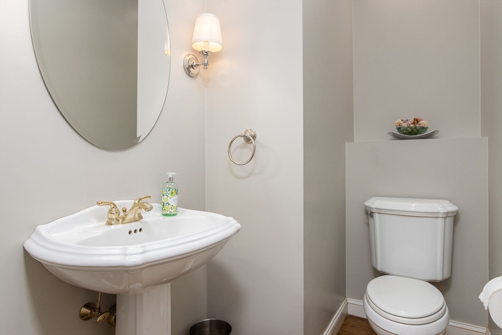 326 Old Ayer Road Groton, MA 01450 - Photo 22 of 42 a bathroom with a sink a toilet and a mirror