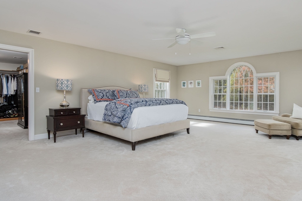 326 Old Ayer Road Groton, MA 01450 - Photo 23 of 42 a spacious bedroom with a bed and a large window