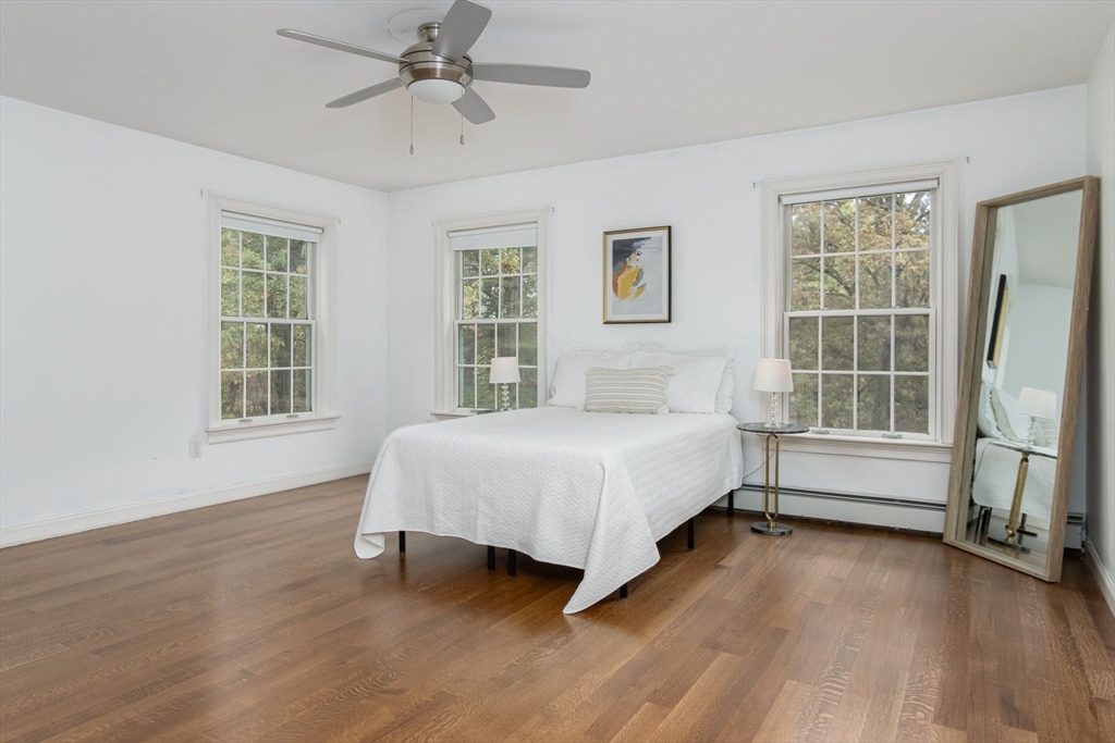 326 Old Ayer Road Groton, MA 01450 - Photo 27 of 42 a spacious bedroom with a bed and a window