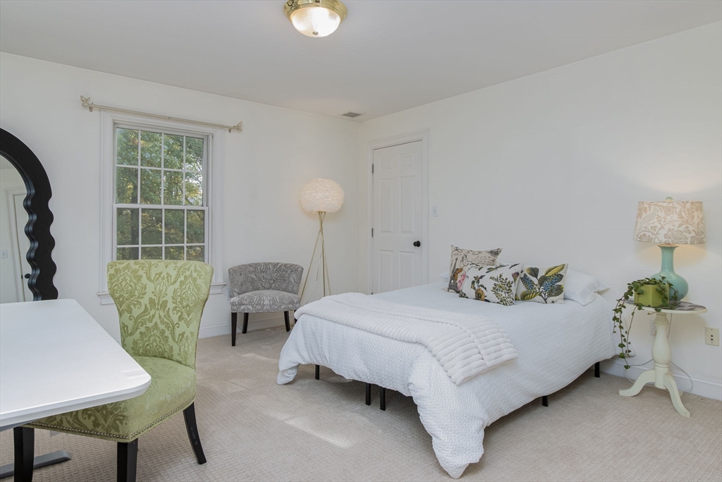 326 Old Ayer Road Groton, MA 01450 - Photo 29 of 42 a bedroom with a bed and a table