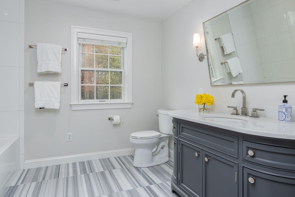 326 Old Ayer Road Groton, MA 01450 - Photo 31 of 42 a bathroom with a sink a toilet and a window