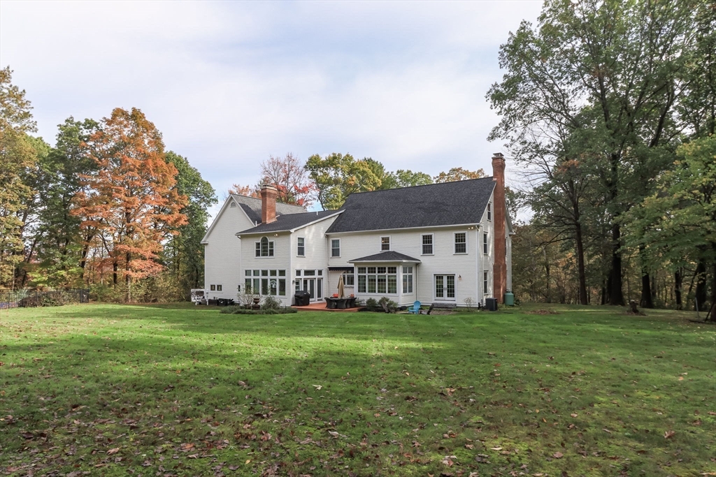 326 Old Ayer Road Groton, MA 01450 - Photo 35 of 42 a view of a house with a big yard and large trees