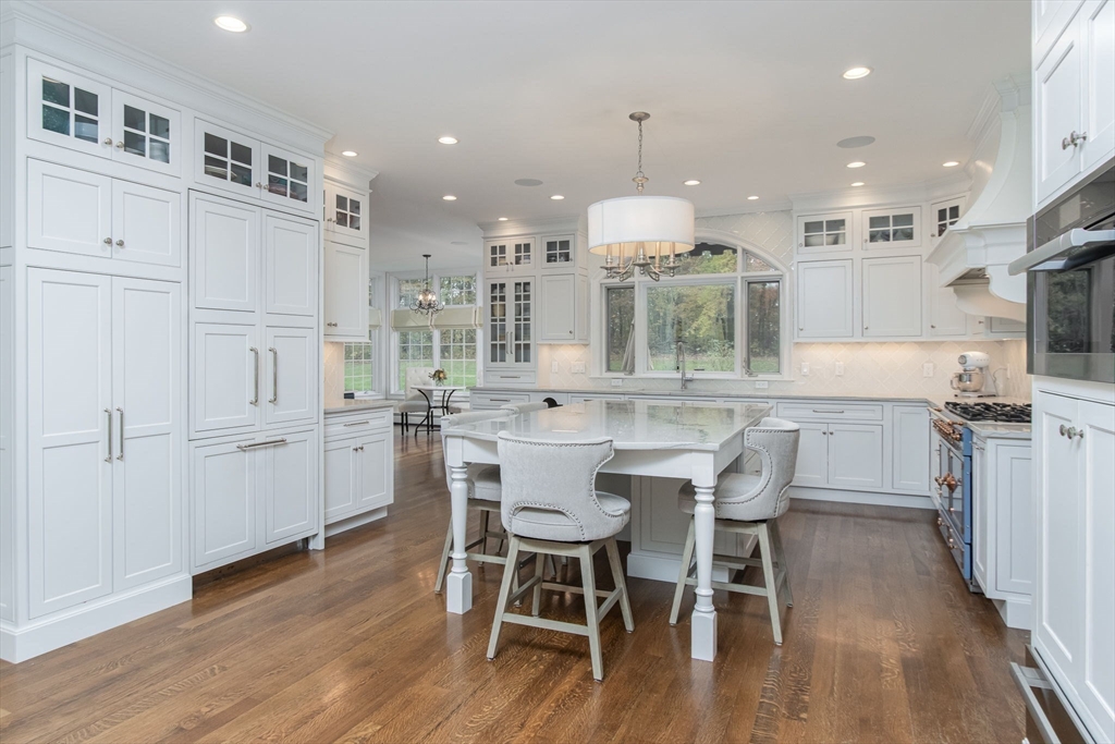 326 Old Ayer Road Groton, MA 01450 - Photo 6 of 42 a large kitchen with kitchen island a dining table and chairs
