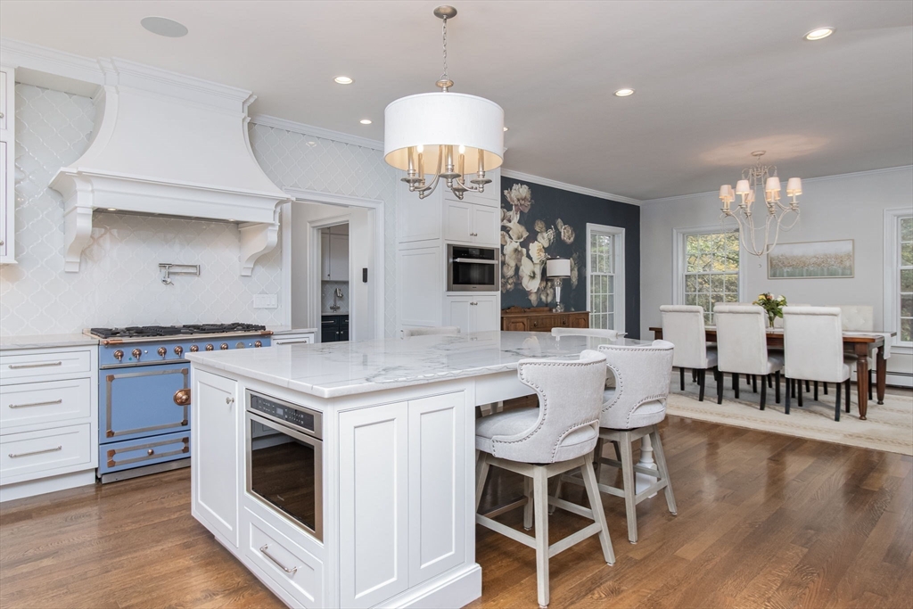 326 Old Ayer Road Groton, MA 01450 - Photo 8 of 42 a kitchen with a stove and chairs