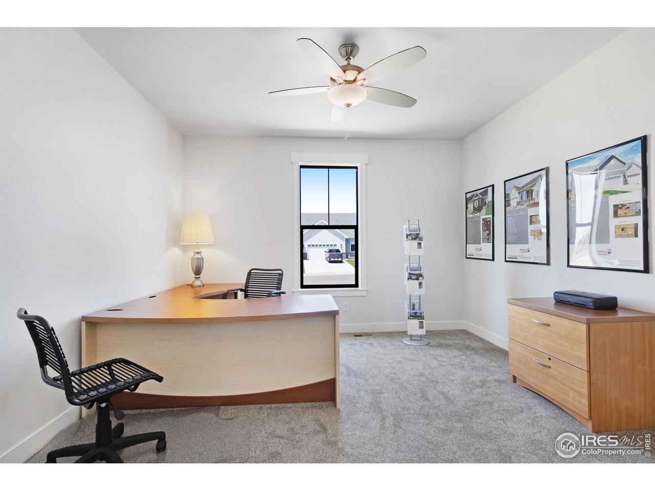 5706 3rd Street Greeley, CO 80634 - Photo 22 of 34 The second bedroom (at the front of the home), acting as a marketing center in this shot
