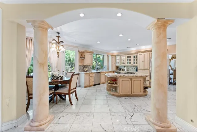 a kitchen with a sink and chairs