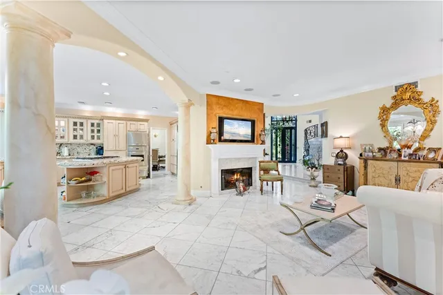 a living room with fireplace furniture and a large window