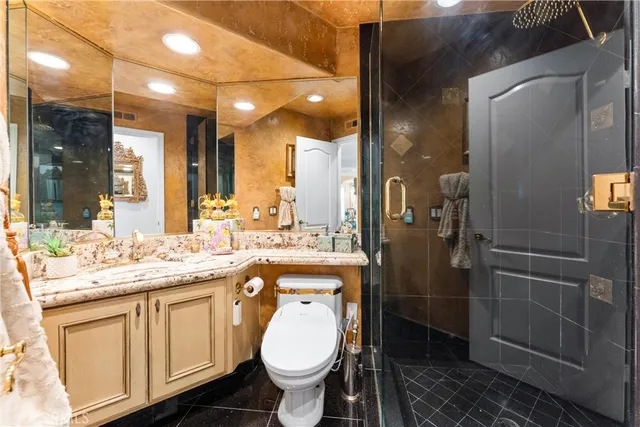 a bathroom with a sink toilet and shower