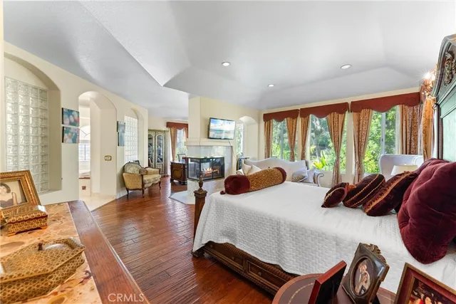 a bedroom with furniture and a large window