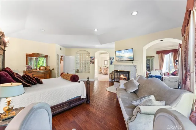 a bedroom with furniture and a fireplace