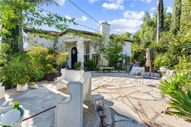 a view of a patio with table and chairs and potted plants