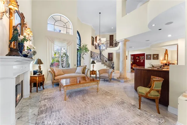 a living room with fireplace furniture and a chandelier