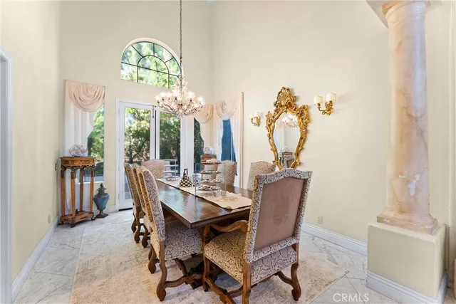 a dining room with furniture and a chandelier
