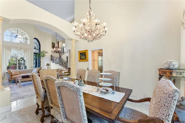 a living room with furniture a chandelier and a window