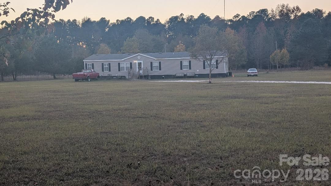 a view of house with outdoor space and garden