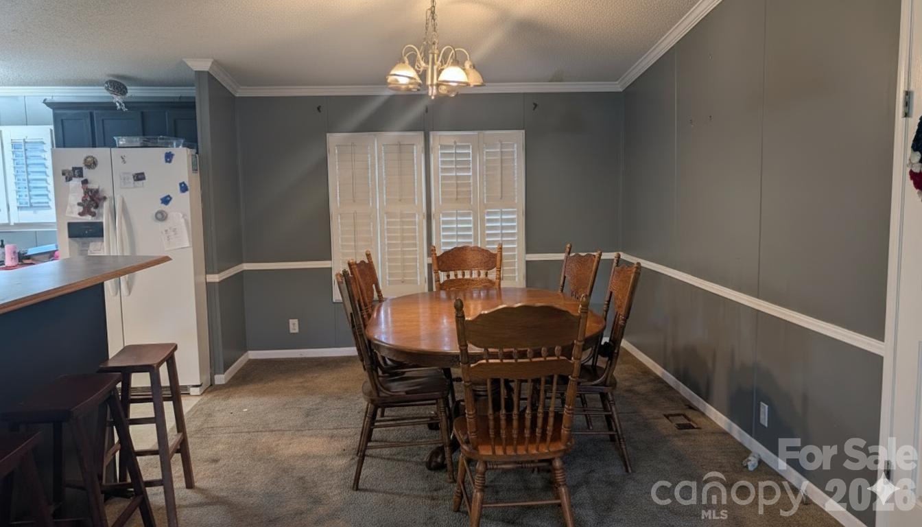 1163 Pit A Tat Road Kershaw, SC 29067 - Photo 6 of 13 a view of a dining room with furniture and chandelier