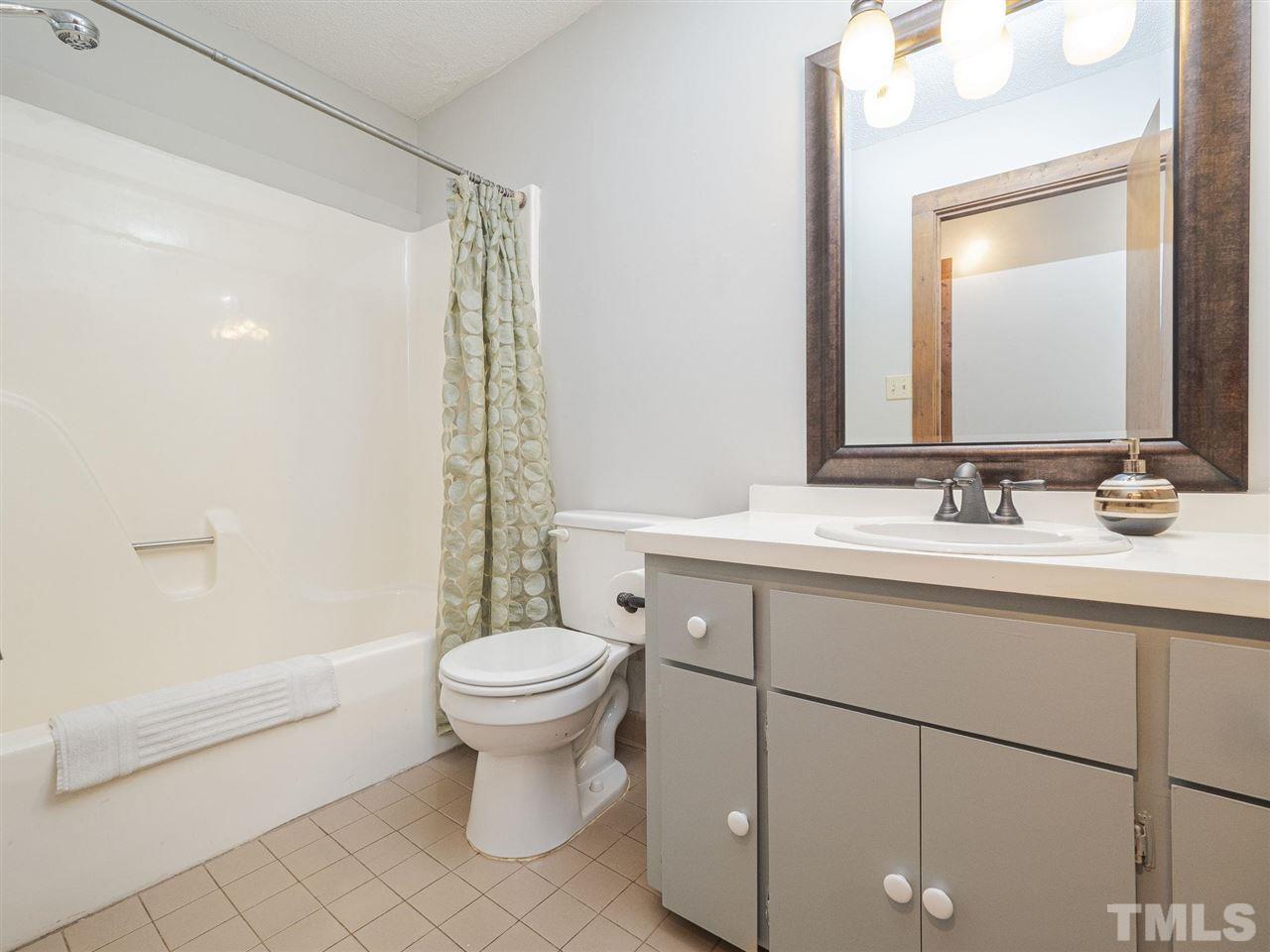 7220 Bluffside Court Raleigh, NC 27615 - Photo 16 of 23 a bathroom with a sink toilet and shower