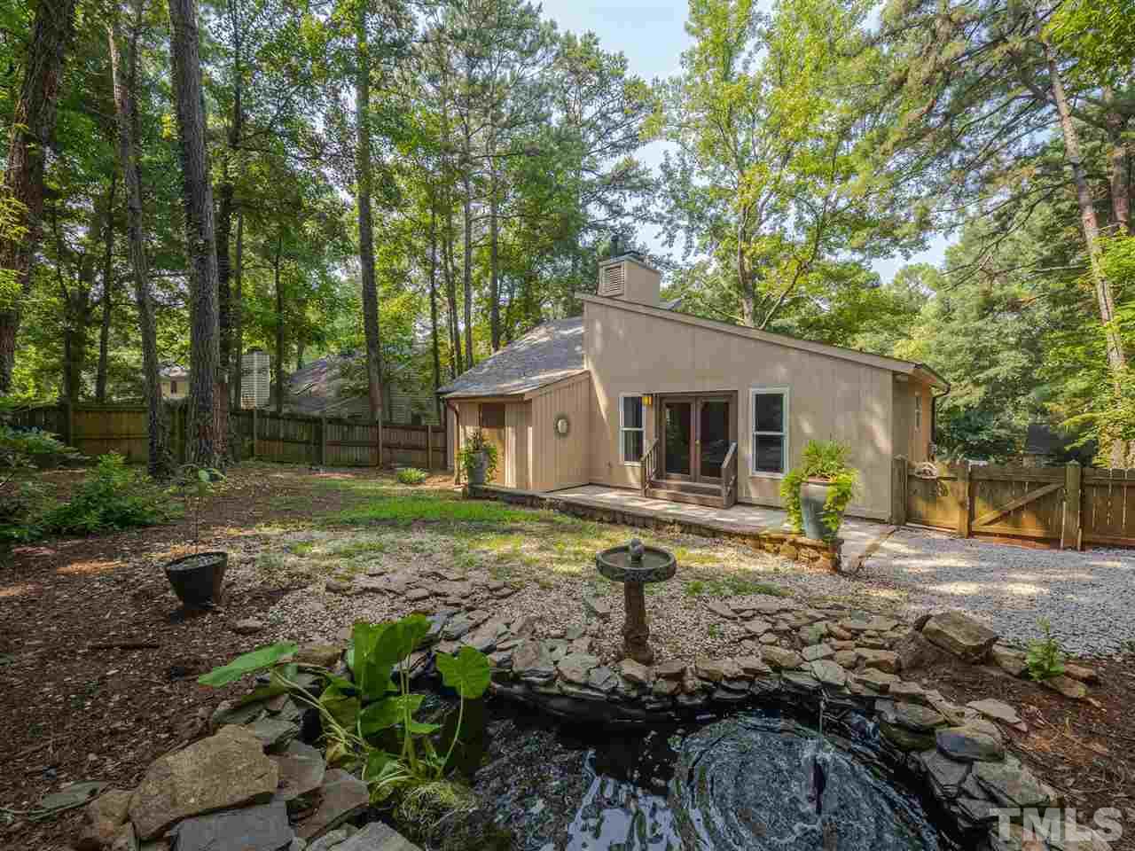 7220 Bluffside Court Raleigh, NC 27615 - Photo 19 of 23 a view of a yard with plants and trees