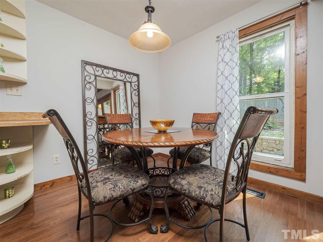 7220 Bluffside Court Raleigh, NC 27615 - Photo 7 of 23 a view of a dining room with furniture and wooden floor