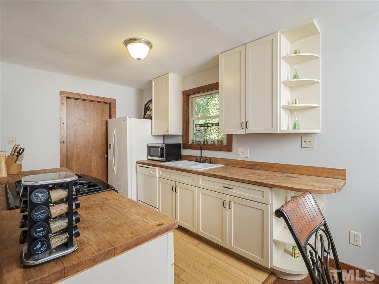 7220 Bluffside Court Raleigh, NC 27615 - Photo 8 of 23 a kitchen with stainless steel appliances granite countertop a sink stove and cabinets