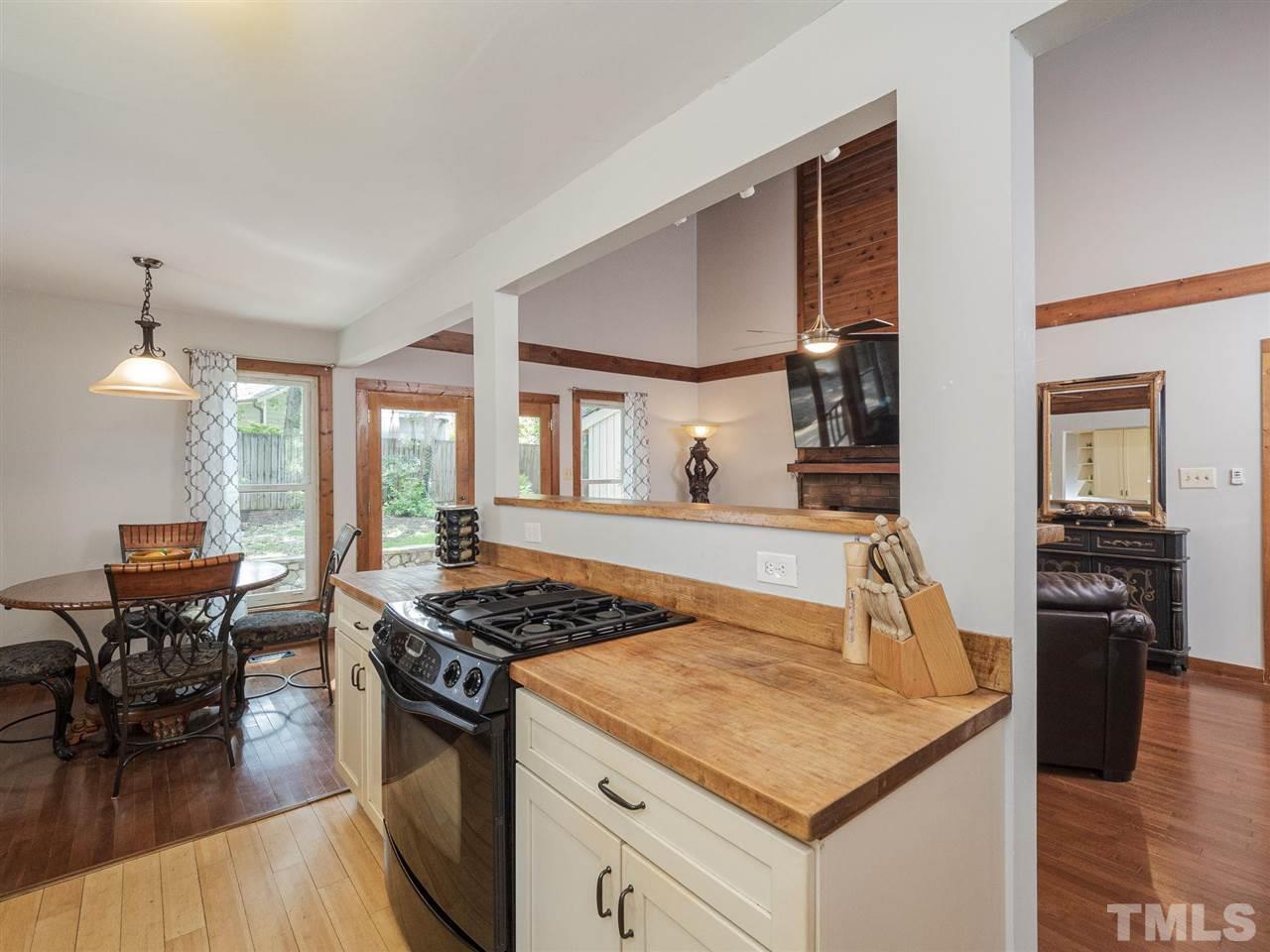 7220 Bluffside Court Raleigh, NC 27615 - Photo 10 of 23 a kitchen with a stove and a dining table
