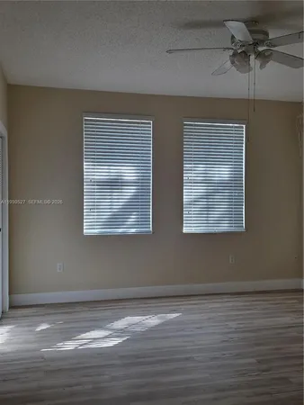 a view of a small space with wooden floor and a window