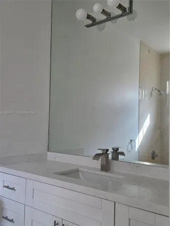a bathroom with a shower and vanity
