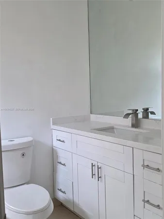 a bathroom with a sink a toilet and vanity