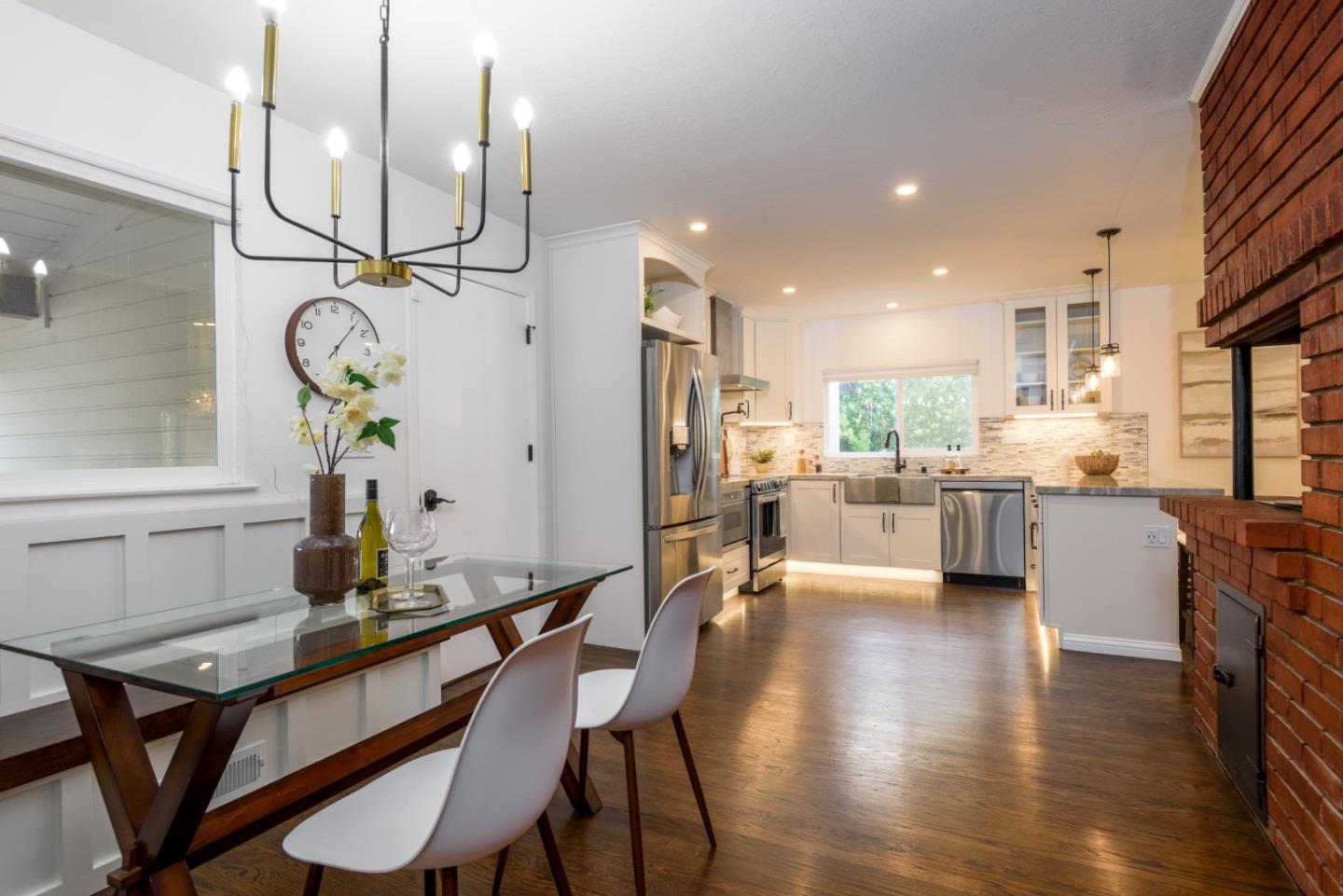1420 South Mary Avenue Sunnyvale, CA 94087 - Photo 11 of 24 a kitchen with stainless steel appliances kitchen island granite countertop a table chairs in it and wooden floors